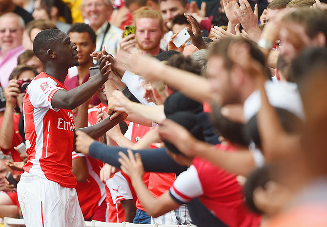 Yaya Sanogo of Arsenal celebrates scoring his 4th goal with fans during the Emirates Cup match between Arsenal and Benfica at the Emirates Stadium on Saturday