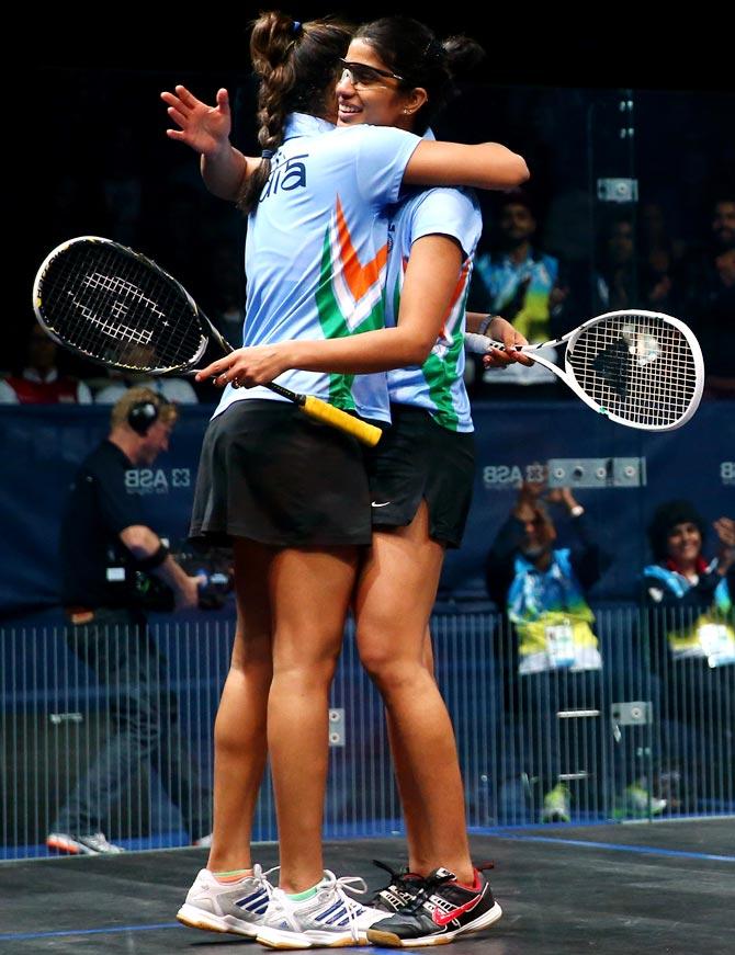 Dipika Pallikal (left) and Joshana Chinappa of India celebrate winning the gold medal