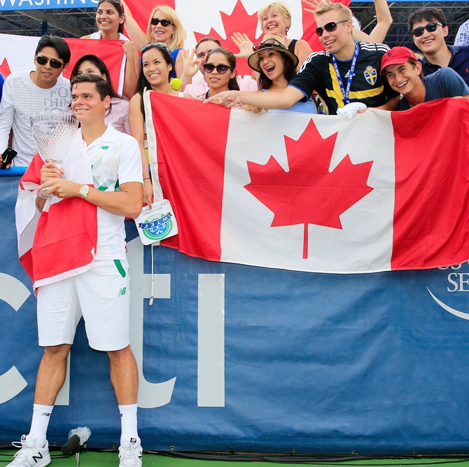 Milos Raonic of Canada poses with fans after defeating Vasek Pospisil of Canada during the mens final of the Citi Open at the William HG FitzGerald Tennis Center