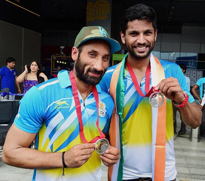 Indian Hockey team captain Sardara Singh (left) and the team's top scorer Rupinder Pal Singh pose for photographers on their arrival from the Glasgow Commonwealth on Tuesday 