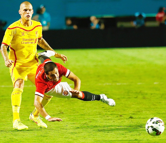Javier Hernandez  of Manchester United is tackled by Martin Skrtel of Liverpool