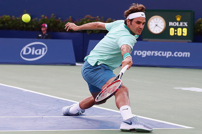 Roger Federer of Switzerland returns a shot to Peter Polansky of Canada during Rogers Cup at Rexall Centre at York University in Toronto, Canada, on Tuesday