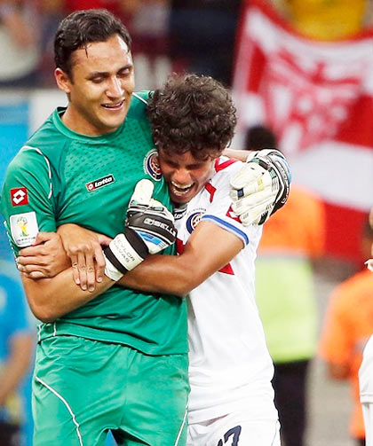 Costa Rica midfielder Yeltsin Tejeda (17) hugs goalkeeper Keylor Navas