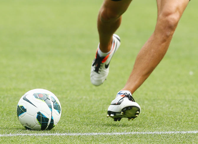 A player kicks a soccer ball