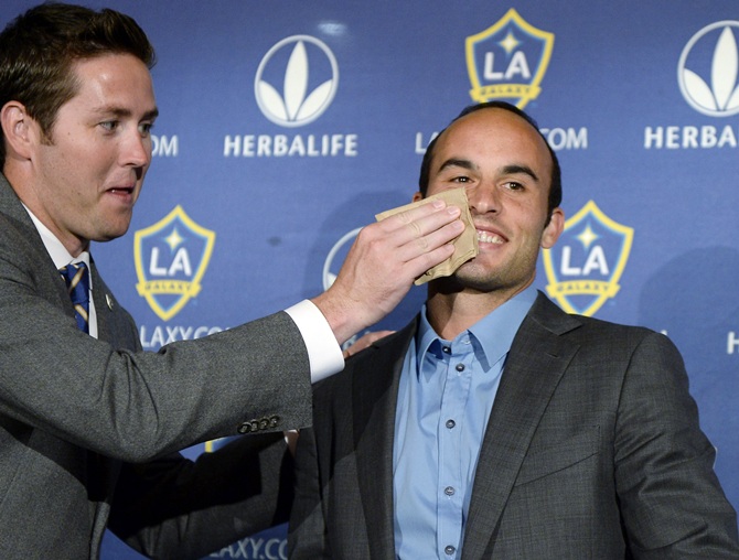 Brendan Hannan wipes lipstick from the right cheek of Landon Donovan of the Los Angeles   Galaxy after he announced his retirement following the 2014 MLS season during a news conference