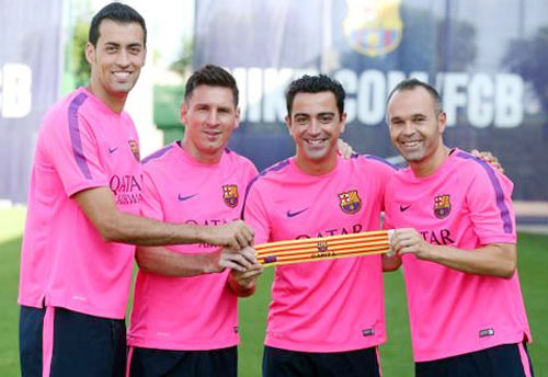 Barcelona's Sergio Busquets, Lionel Messi, Xavi Hernandez and Andres Iniesta pose with the captain's armband on Thursday