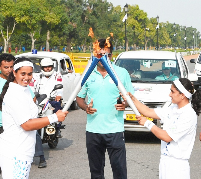 Shreyasi Singh, left, during the torch relay ceremony of 17th Asian Games 2014 at Rajpath in New Delhi on Saturday