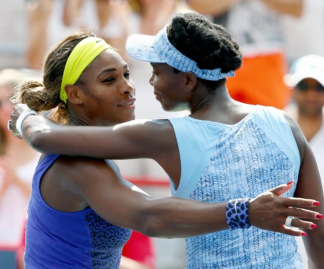 Serena Williams (left) hugs her sister Venus after the match