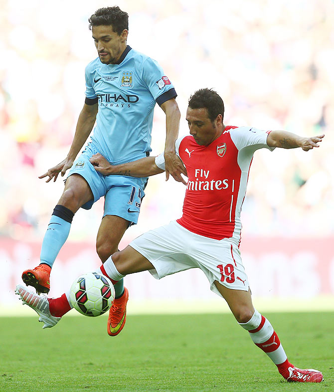Jesus Navas of Manchester City is challenged by Santi Cazorla of Arsenal during the FA Community Shield match on Sunday