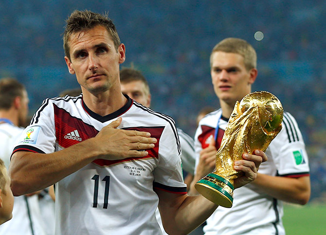 Germany's Miroslav Klose holds the World Cup trophy after the 2014 World Cup final against Argentina at the Maracana stadium in Rio de Janeiro
