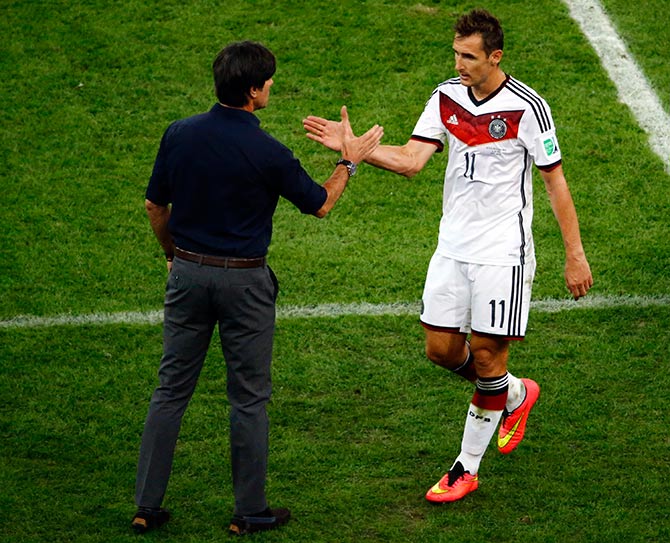 Germany's Miroslav Klose (R) shakes hands with coach Joachim Loew
