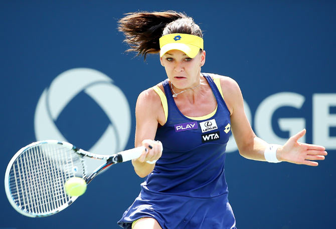 Agnieszka Radwanska of Poland returns a shot to Venus Williams of the USA on Sunday