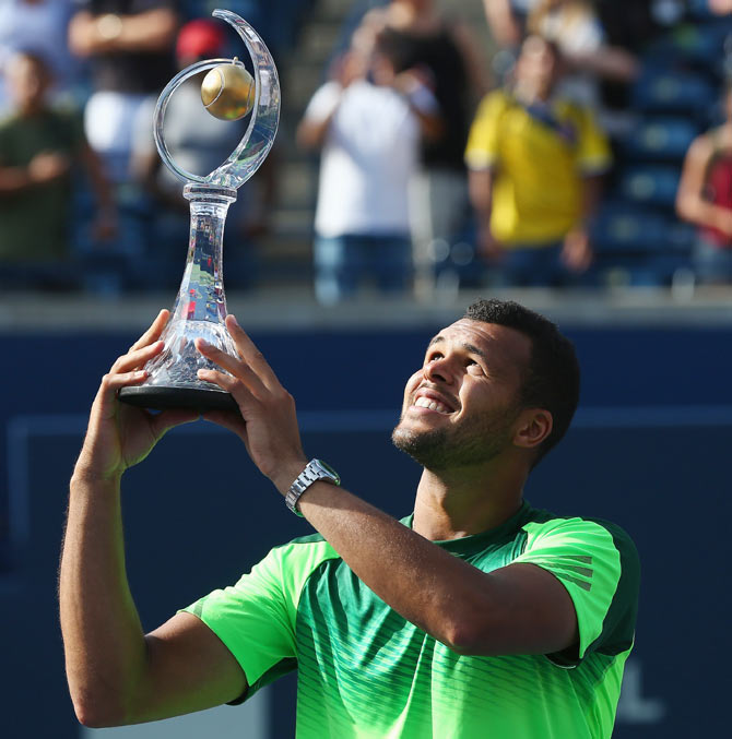Jo-Wilfried Tsonga of France holds up the Rogers Cup trophy after his win against Roger Federer of Switzerland during the finalRexall Centre at York University in Toronto on Sunday