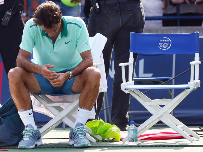 Roger Federer of Switzerland sits in his chair after his loss to Jo-Wilfried Tsonga of France in the final match of the Rogers Cup at Rexall Centre at York University on Sunday