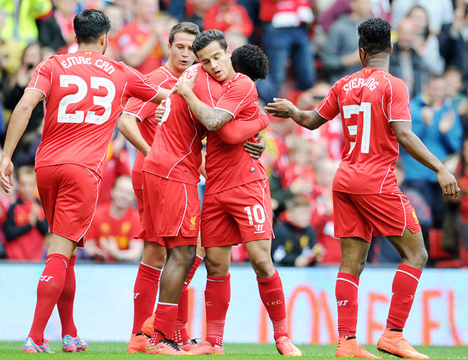 Daniel Sturridge (centre) of Liverpool celebrates with team-mate Philippe Coutinho after scoring
