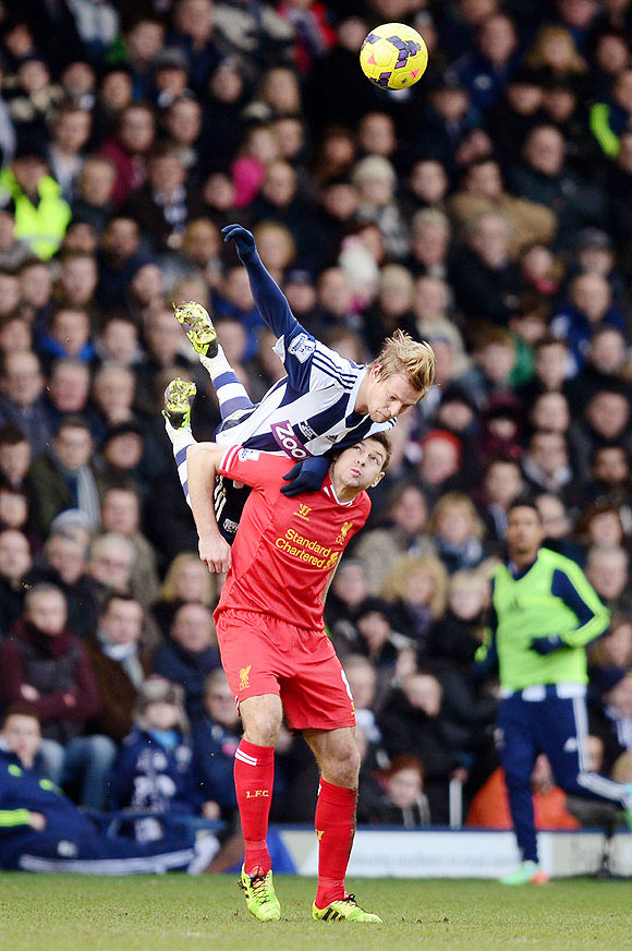 Matej Vydra of West Bromwich climbs above Steven Gerrard of Liverpool to win a header during their Premier League match at The Hawthorns in West Bromwich