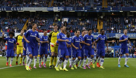 Chelsea players celebrate after winning a game