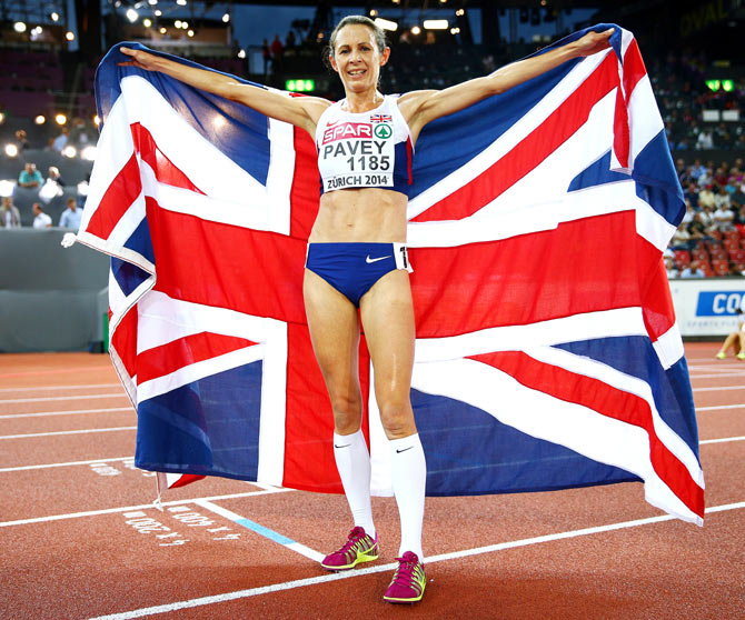 Jo Pavey of Great Britain and Northern Ireland poses with a Union Jack after winning gold in the Women's 10,000 metres final during day one of the 22nd European Athletics Championships at Stadium Letzigrund on Tuesday