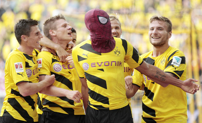 Borussia Dortmund's Pierre-Emerick Aubameyang (with Spiderman mask) and teammates celebrate a goal against Bayern Munich during their SuperCup 2014 soccer match in Dortmund on Wednesday