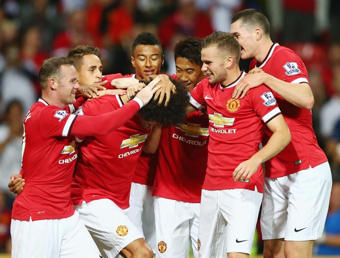 Manchester United players celebrate a goal during the pre-season friendly match against Valencia at Old Trafford in Manchester on August 12, 2014.