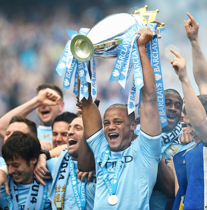 Vincent Kompany of Manchester City lifts the Premier League trophy in May