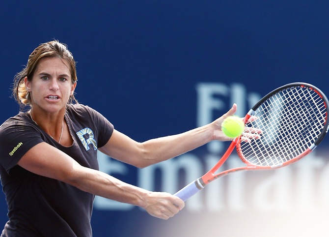 Coach Amelie Mauresmo returns a shot with Andy Murray of Great Britain