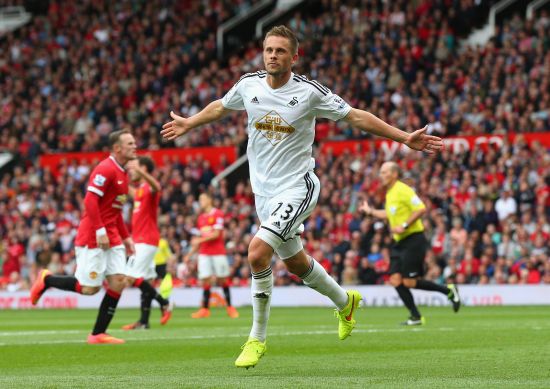 Gylfi Sigurdsson of Swansea City celebrates scoring his team's second goal during the Barclays Premier League match between Manchester United and Swansea City