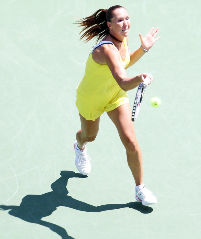 Jelena Jankovic returns a shot against Serena Williams on Friday