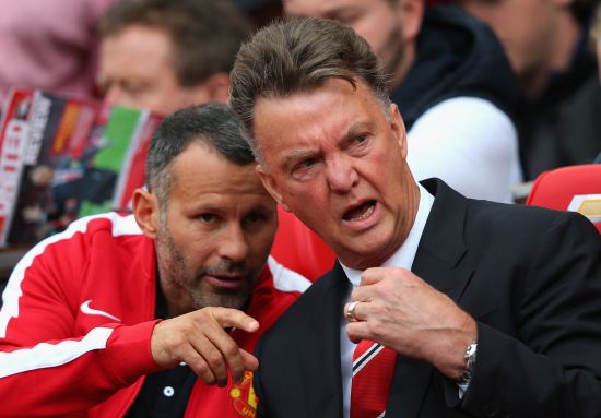 Manchester United Manager Louis van Gaal speaks with Assistant Ryan Giggs (L) prior to the Barclays Premier League match between Manchester United and Swansea City 