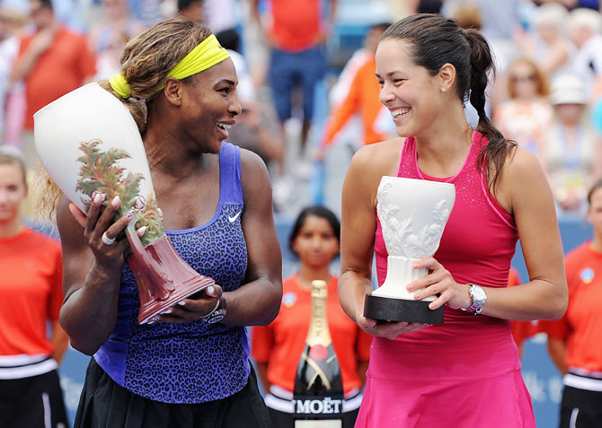 Serena Williams and Ana Ivanovic of Serbia pose with their trophies after the final at Cincinnati on Sunday