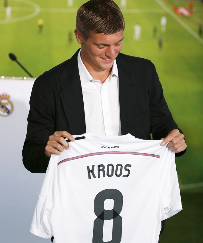Midfielder Toni Kroos of Germany poses holding his new Real Madrid shirt