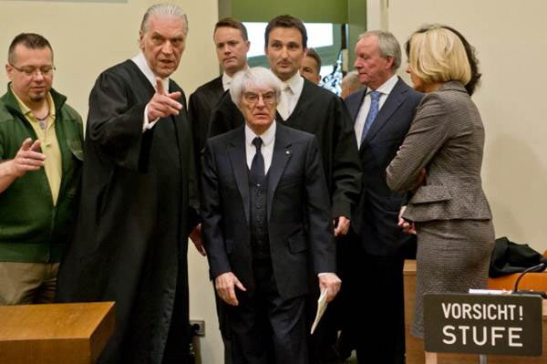 Bernie Ecclestone (centre), the 83-year-old controlling business magnate in Formula One racing, and his lawyers Sven Thomas, Andreas Weitzell and Norbert Scharf arrive for the first day of his trial for bribery in April 2014