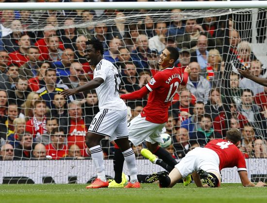 Swansea City's Wilfried Bony, left, celebrates as team mate Ki Sung-Yeung (unseen) scores a goal against Manchester United