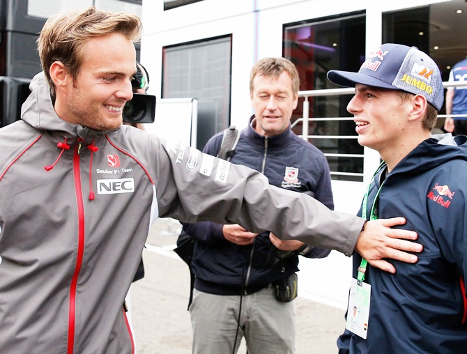 Max Verstappen, who is set to replace Jean-Eric Vergne of France at Scuderia Toro Rosso   next season, speaks with test driver Giedo van der Garde of Netherlands