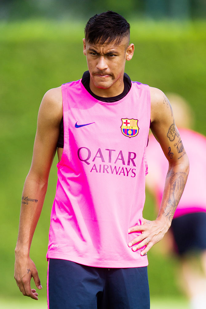 Neymar looks on during a FC Barcelona training session at Ciutat Esportiva on Sunday