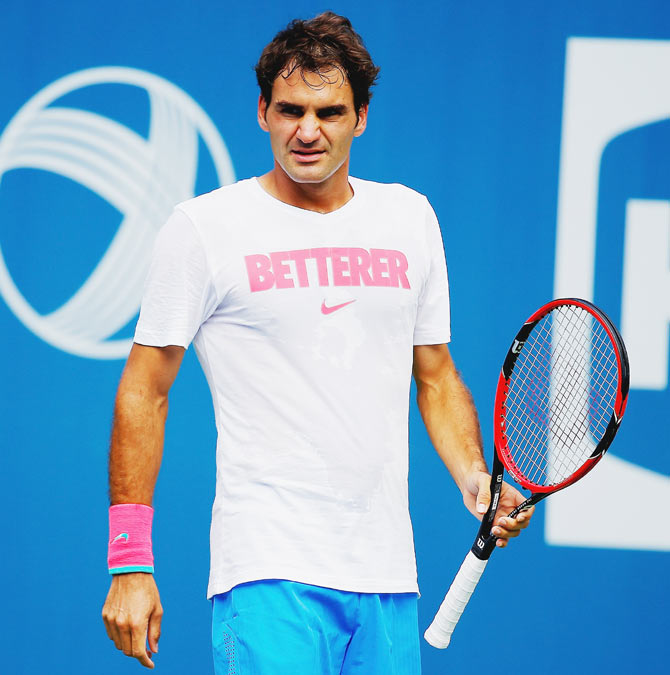 Roger Federer of Switzerland looks on during practice prior to the start of the 2014 U.S. Open at the USTA Billie Jean King National Tennis Center in New York City on Thursday