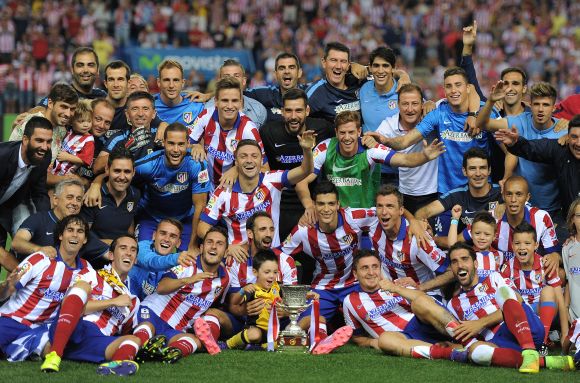 Club Atletico de Madrid players celebrate after beating Real Madrid on aggregate to win the Spanish Supercopa 