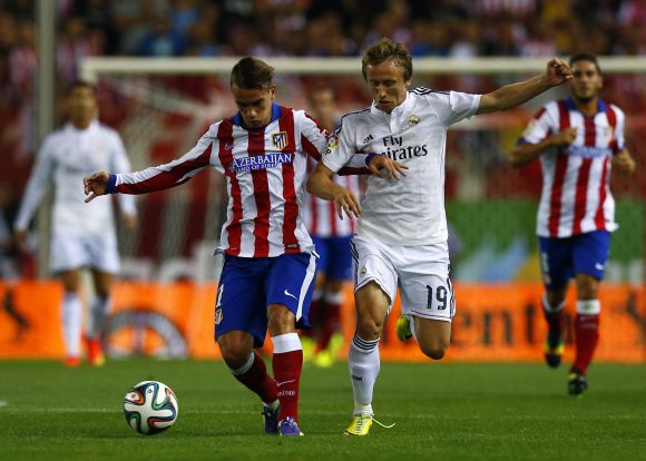 Atletico Madrid's Antoine Griezmann (L) and Real Madrid's Luka Modric fight for the ball during their Spanish Super Cup second leg soccer match 