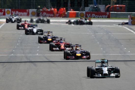 Nico Rosberg of Germany and Mercedes GP leads Sebastian Vettel of Germany and Infiniti Red Bull Racing along the pit straight during the Belgian Grand Prix 