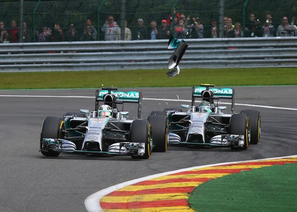 Debris flies in the air as Nico Rosberg of Germany and Mercedes GP makes contact with Lewis Hamilton of Great Britain 
