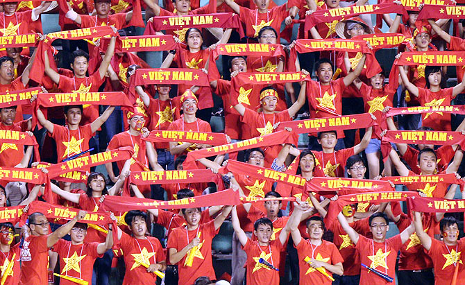 Vietnamese fans cheer during the AFC match