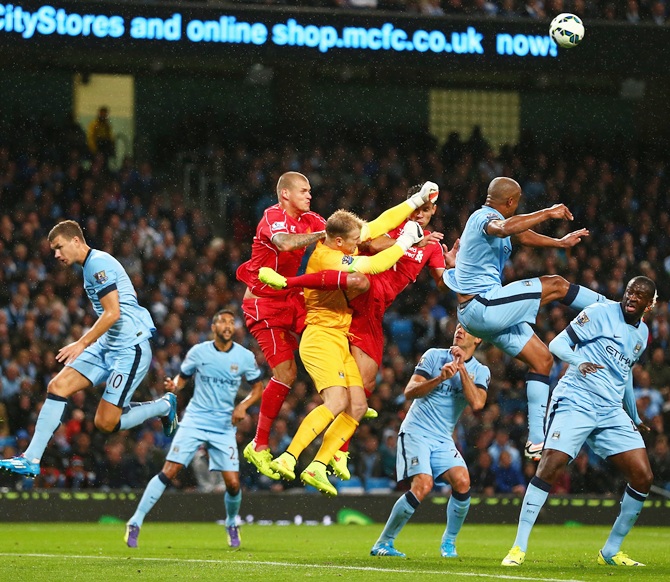 Joe Hart of Manchester City punches clear under pressure