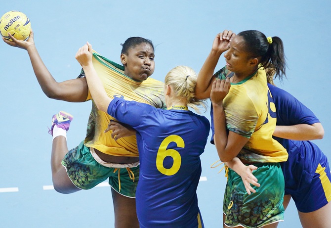 Emma Lindqvist of Sweden challenges Mariana Christina Oliveira Fernandes of Brazil in the women's bronze medal handball match between Brazil and Sweden on Day nine of Nanjing 2014 Summer Youth Olympic Games at Jiangning Sports Centre Gymnasium.
