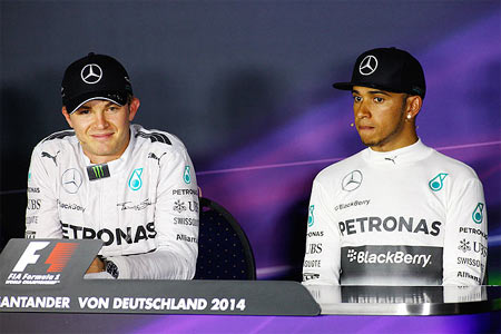Mercedes' Nico Rosberg of Germany smiles next to teammate Lewis Hamilton of Great Britain