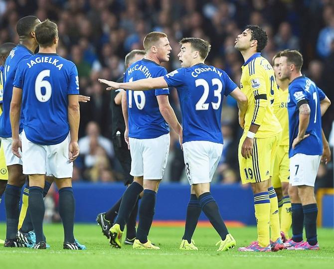 Diego Costa of Chelsea exchanges words with Sylvain Distin of Everton as Seamus   Coleman of Everton intervenes during the Barclays Premier League