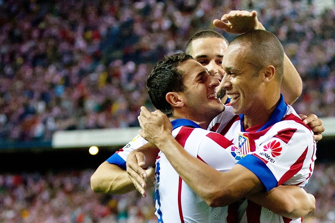 Joao Miranda, right, of Atletico de Madrid celebrates