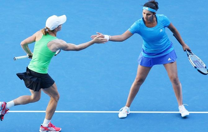 Sania Mirza of India and Cara Black of Zimbabwe in action