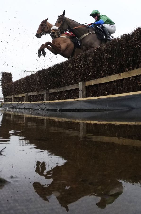 A general view as runners clears the water jump in The bet365 Conditional Jockeys' Handicap Steeple Chase at Newbury racecourse on November 28, 2014 in Newbury, England