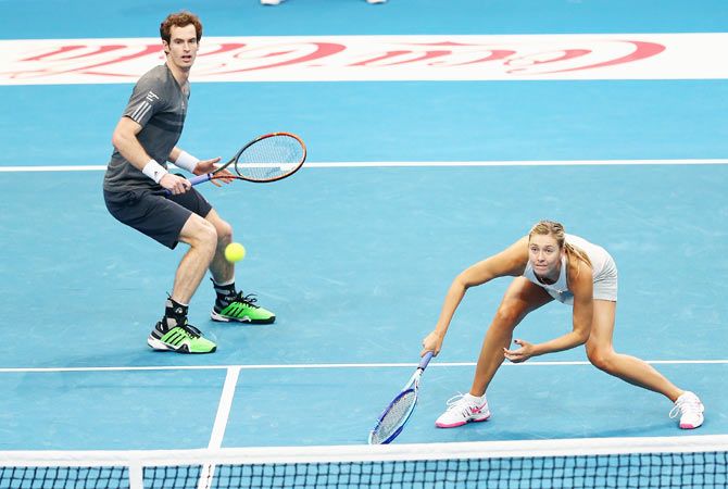Andy Murray and Maria Sharapova of the Manila Mavericks in action against Kristina Mladenovic and Nenad Zimonjic of the UAE Royals during their doubles match at the Coca-Cola International Premier Tennis League