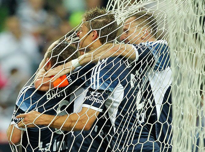 Leigh Broxham of Melbourne Victory celebrates with teammates after scoring against Adelaide United during the round eight A-League match at AAMI Park in Melbourne on November 28